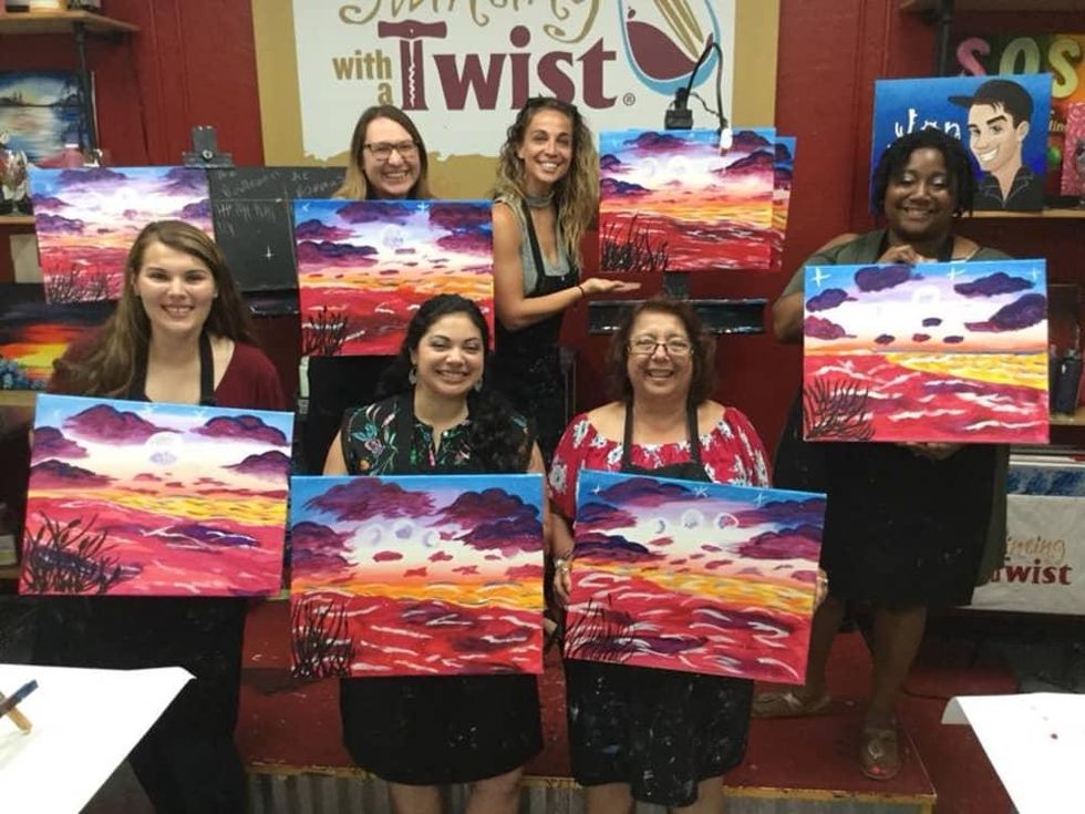 Women showing off their paintings