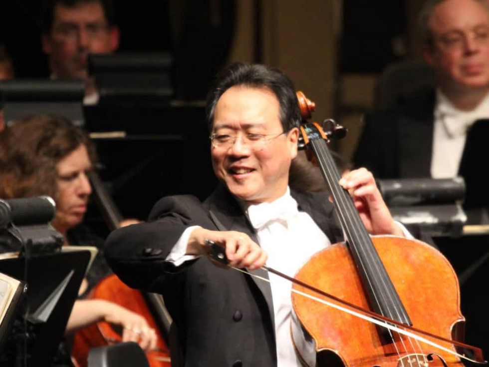 Yo-Yo Ma smiling while playing instrument