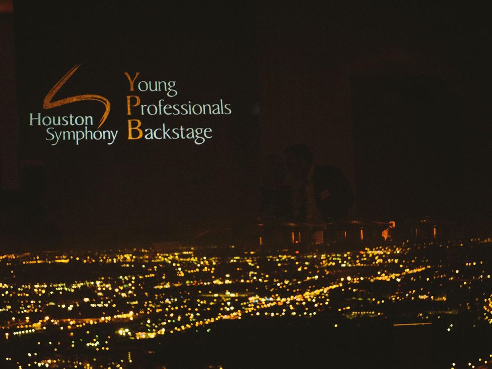 YPB logo reflection in window against city-scape backdrop at Houston Symphony Young Professionals Backstage's Luck be a Lady event November 2013